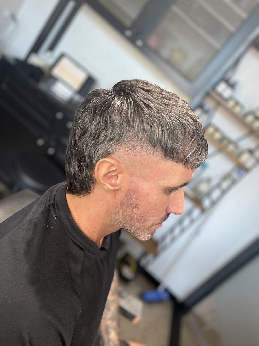 Salt-and-pepper modern mullet with a skin fade